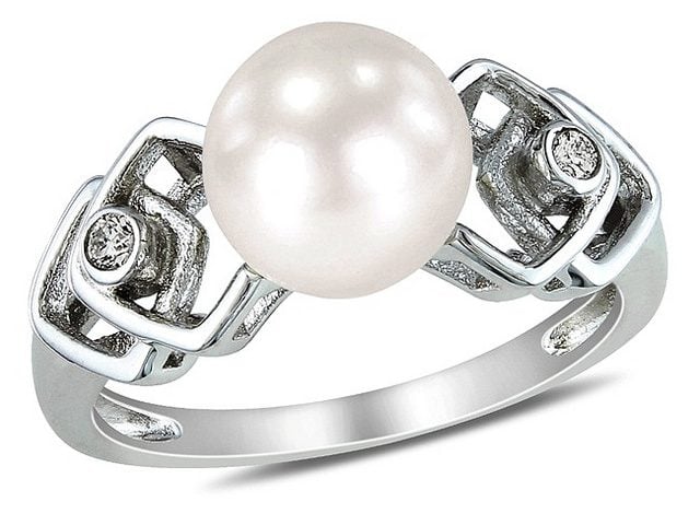 Pearl wedding band with diamond chips encrusted in white gold setting.