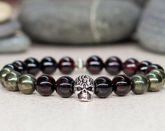This punk style pearl bracelet features a silver skull.