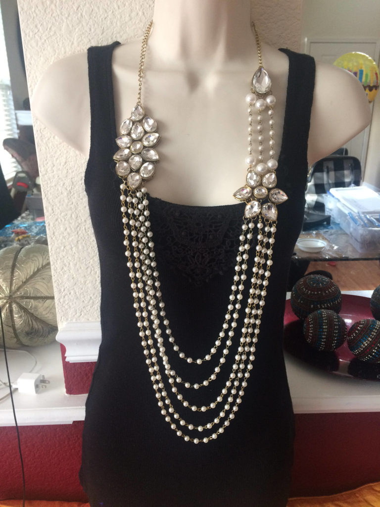 Layers of white pearls connected by multiple brooches.