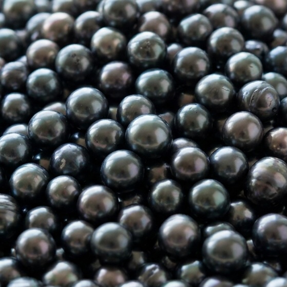 A pile of black Tahitian pearls