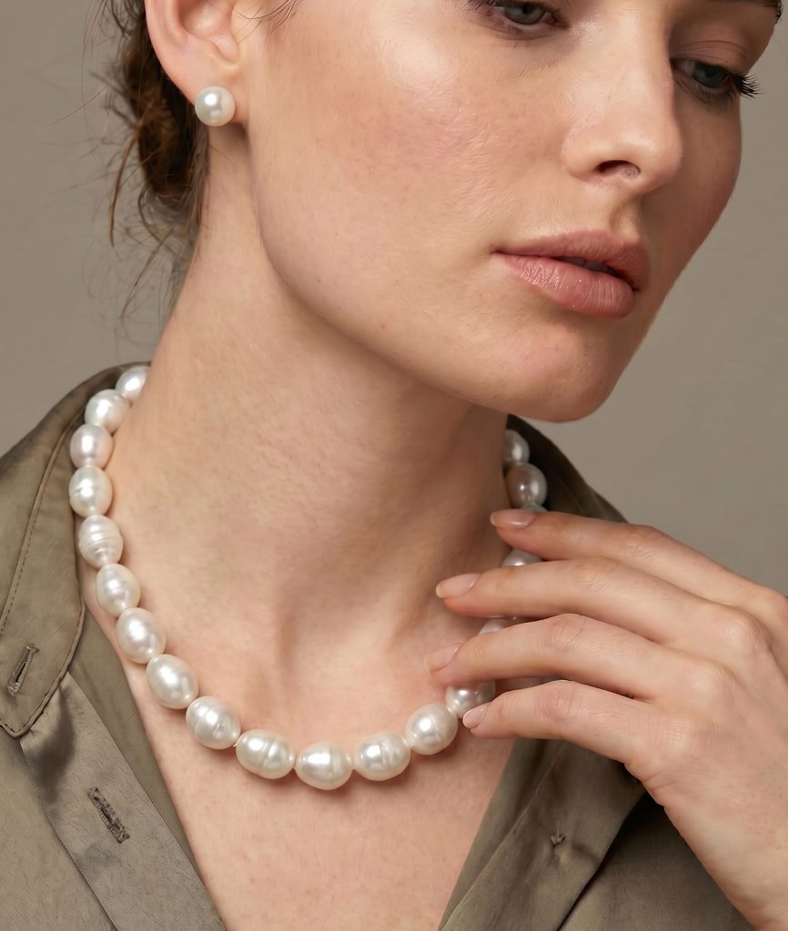 A woman wears a necklace of large South Sea baroque pearls.